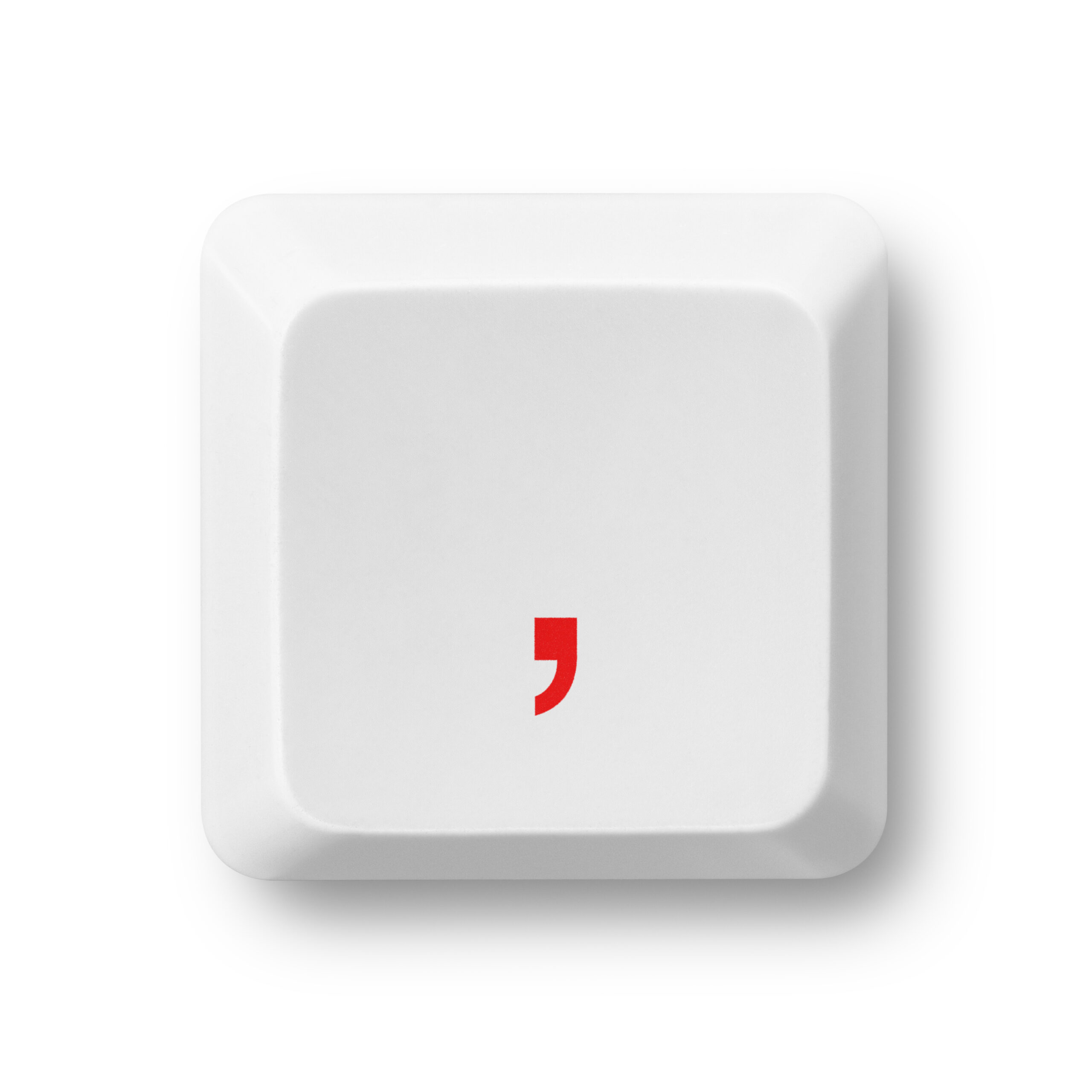 A white keyboard key with a red comma