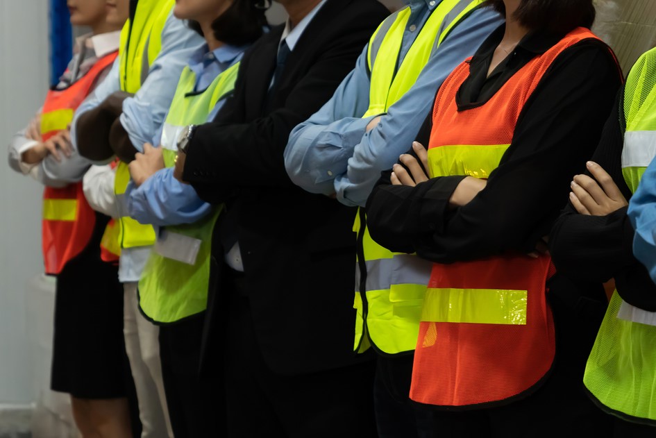 This article shares how communicators can help navigate employee unionization efforts. This image shows employees in construction vests with their arms crossed.